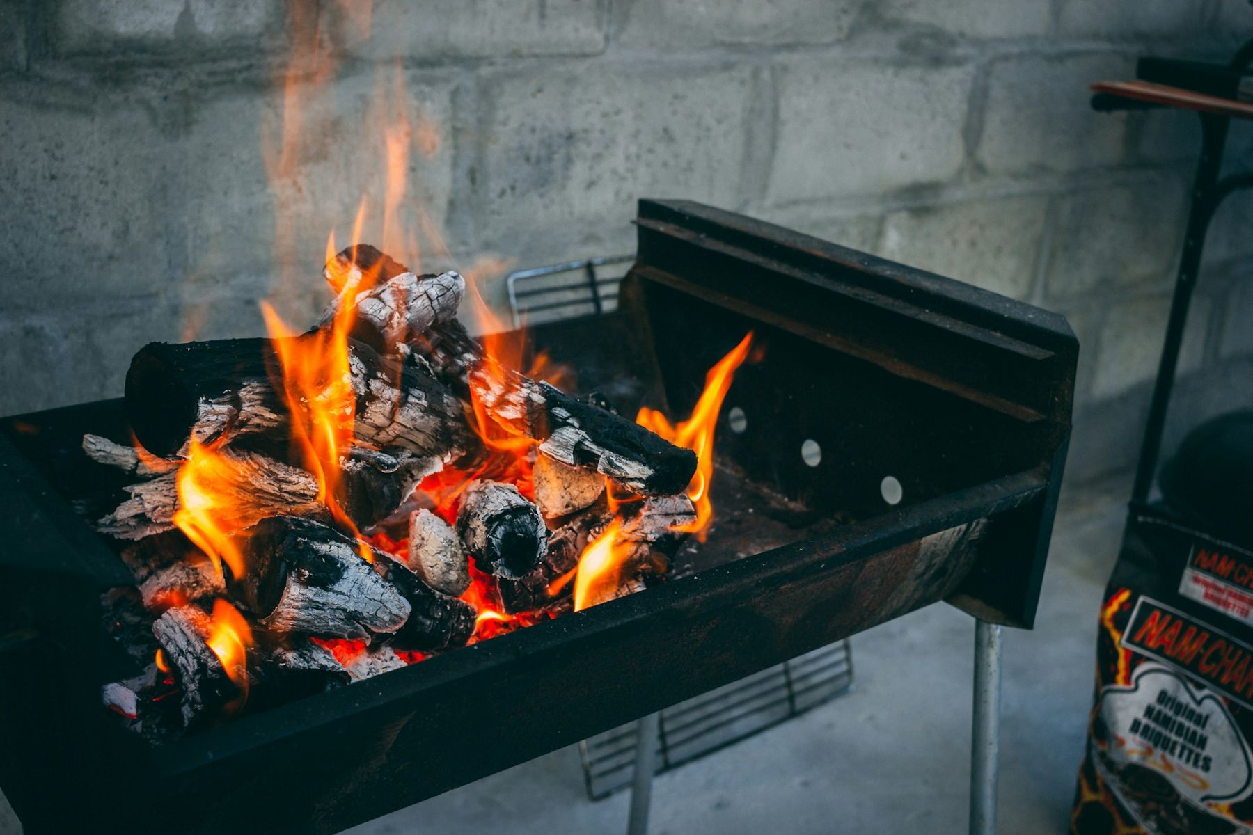 Flames and glowing coals in a braai